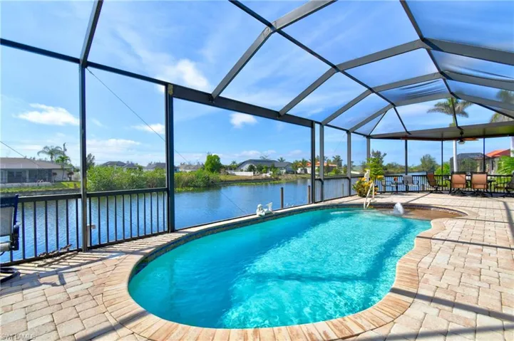 View of swimming pool featuring a water view, a lanai, and a patio area