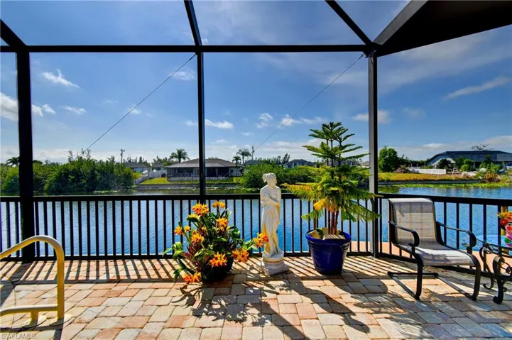 View of patio featuring a water view and a lanai