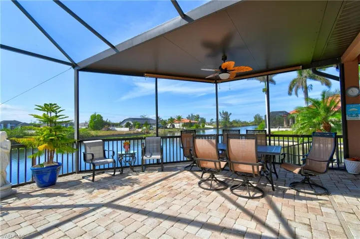 Sunroom / solarium featuring a water view and ceiling fan