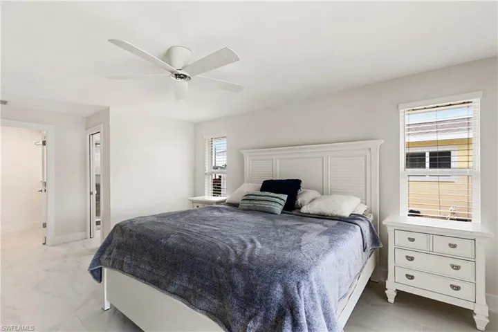 Bedroom featuring ceiling fan and baseboards
