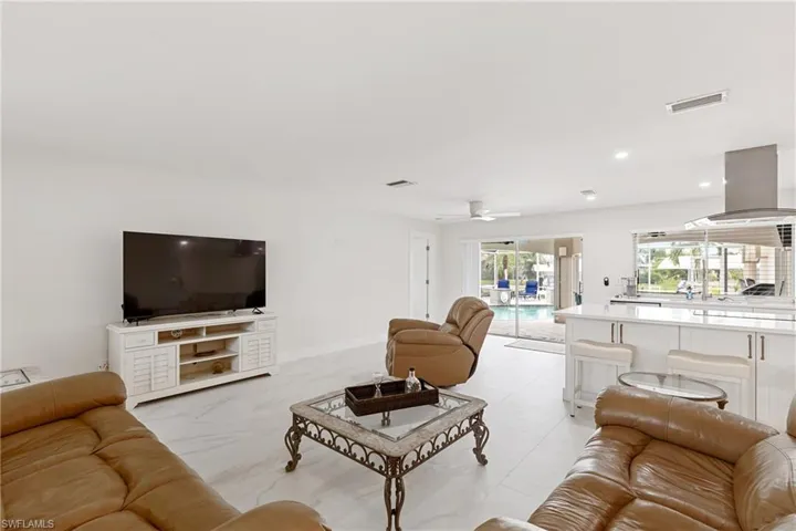 Living room with recessed lighting and ceiling fan