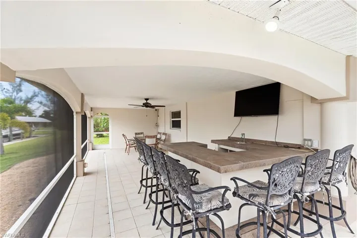 View of patio / terrace featuring a sunroom and a ceiling fan