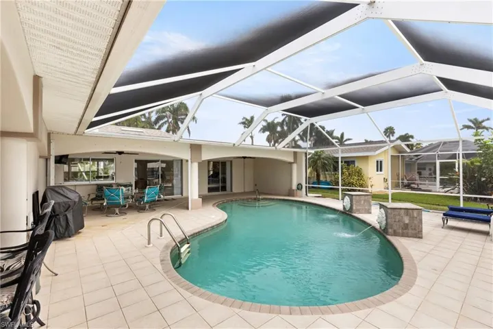 Outdoor pool featuring a patio area, a sunroom, a lanai, and a ceiling fan