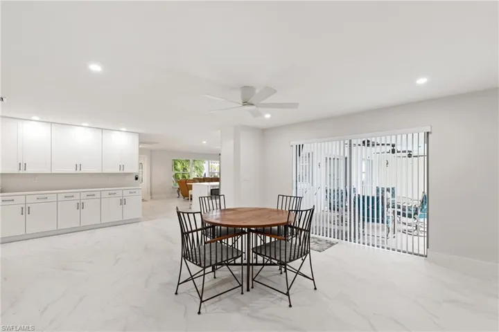Dining area with light marble finish flooring, recessed lighting, and a ceiling fan
