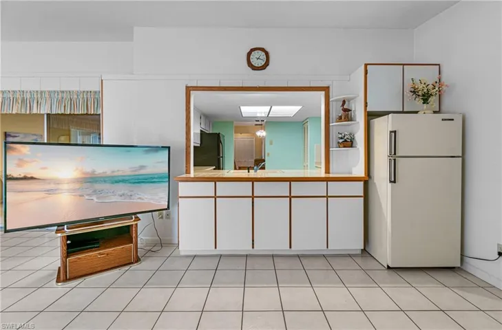 Pass Thru Window to Family Room with refrigerator.