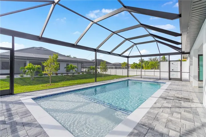 Swimming pool featuring a sunroom, a lanai, and a patio area