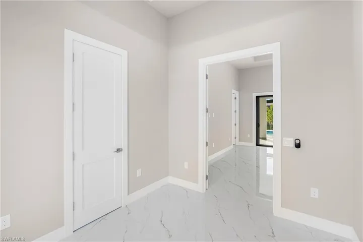 Empty room featuring baseboards and light marble finish flooring