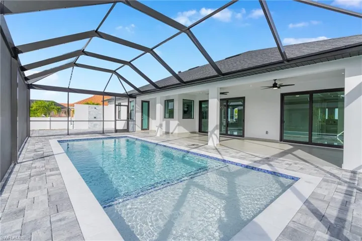 View of swimming pool featuring a sunroom, a lanai, and a patio area