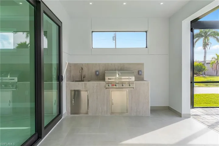 View of patio / terrace featuring an outdoor kitchen and a sink
