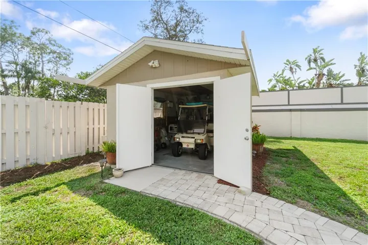 View of outbuilding featuring a lawn