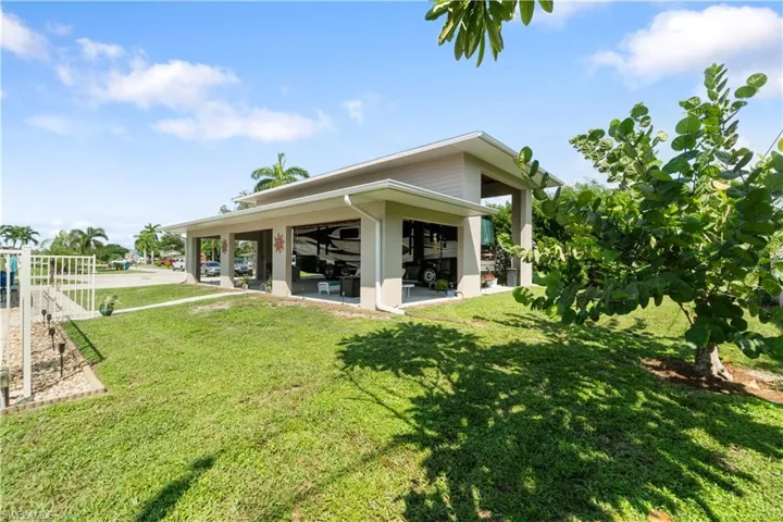 Back of property with a patio and a yard