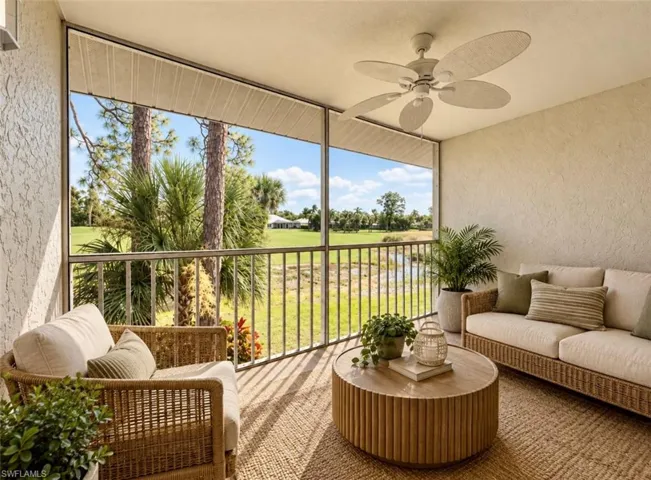 **Virtually staged Screened-in lanai featuring a textured stucco finish, overhead paddle fan, and metal baluster railing