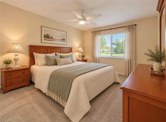 **Virtually staged Neutral-toned interior featuring wall-to-wall carpeting, a multi-blade ceiling fan, and a large window with sliding panes