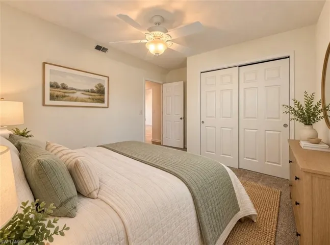 **Virtually staged Room featuring neutral wall tones, a ceiling fan with integrated lighting, and dual sliding doors with a six-panel design