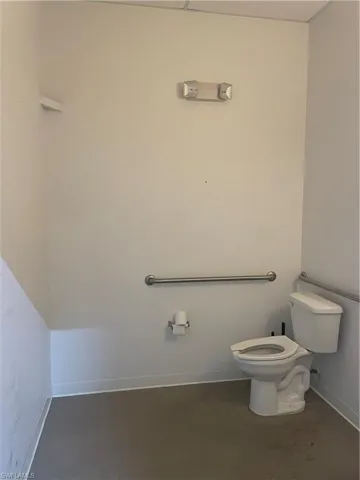 Bathroom with concrete flooring and toilet