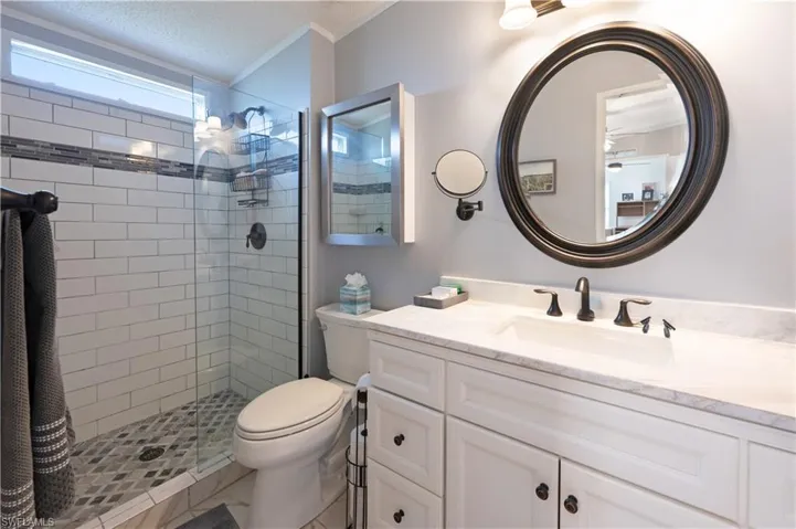 Full bathroom with a shower stall, toilet, vanity, and a textured ceiling