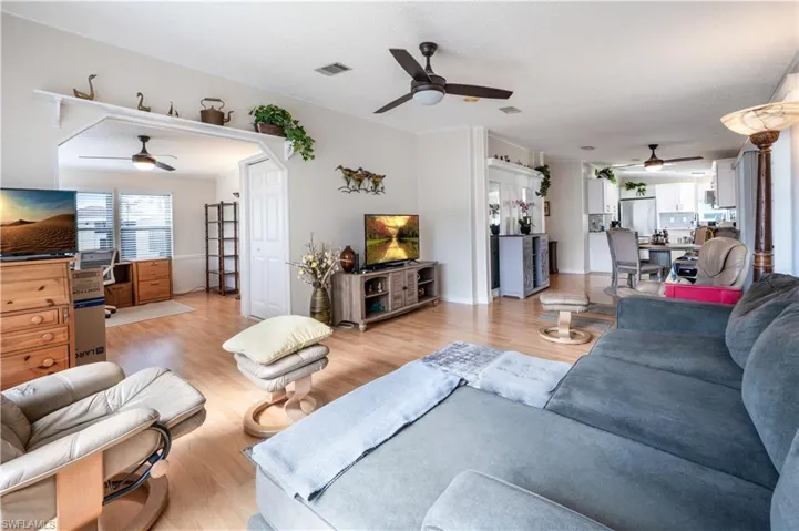 Living area featuring ceiling fan and light wood-style flooring