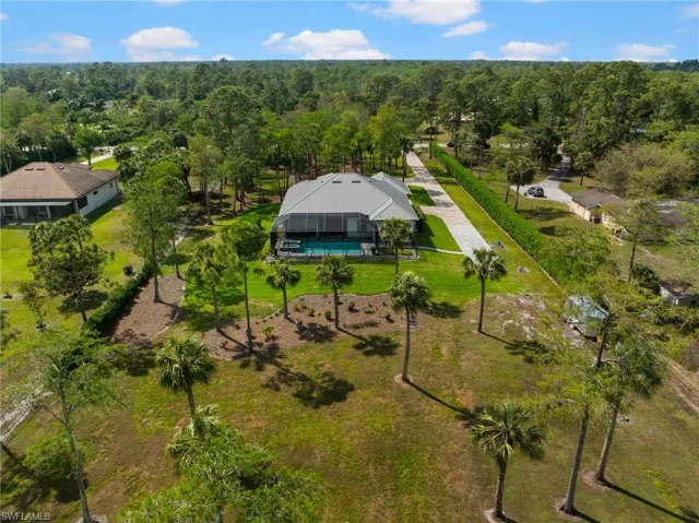 Drone / aerial view featuring a wooded view