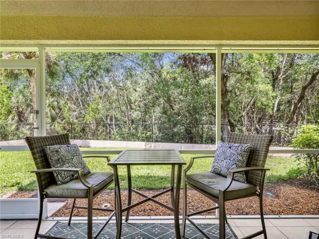 Sunroom with view of scattered trees