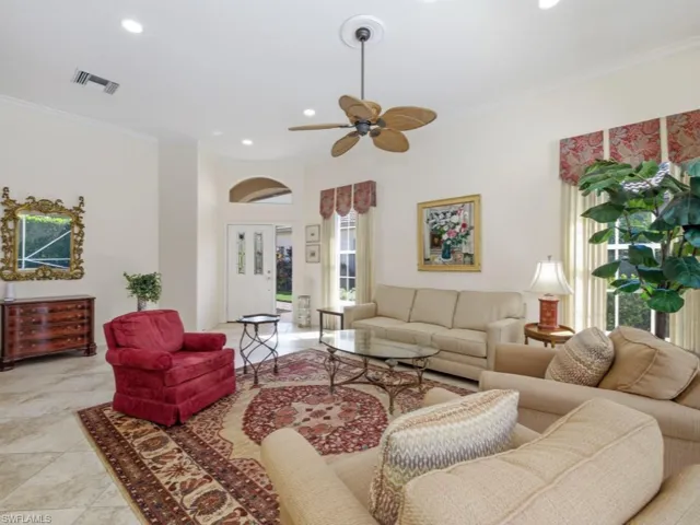 Living room with crown molding, ceiling fan, recessed lighting, and light tile patterned floors