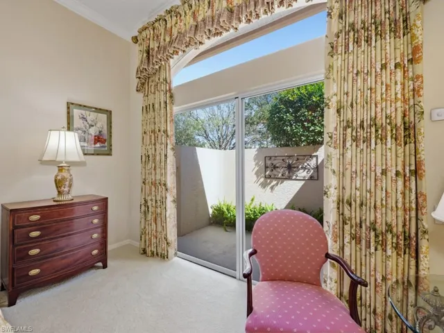Sitting room with ornamental molding and carpet