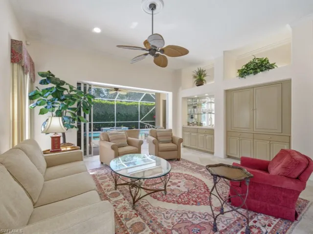 Living area with a sunroom, ceiling fan, recessed lighting, and crown molding