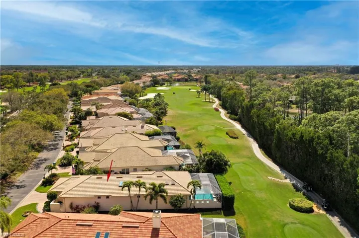 Aerial perspective of suburban area featuring a local golf course