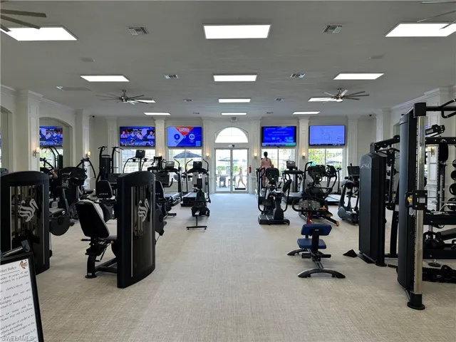 Exercise room featuring ceiling fan and crown molding