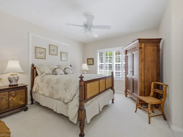 Bedroom with light carpet and ceiling fan