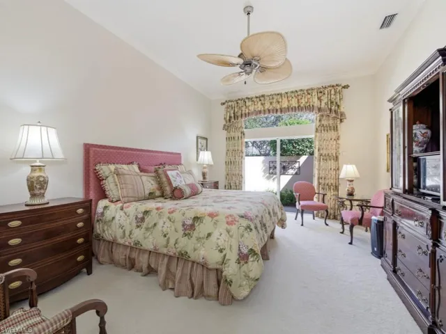 Bedroom with carpet, a ceiling fan, ornamental molding, and access to exterior