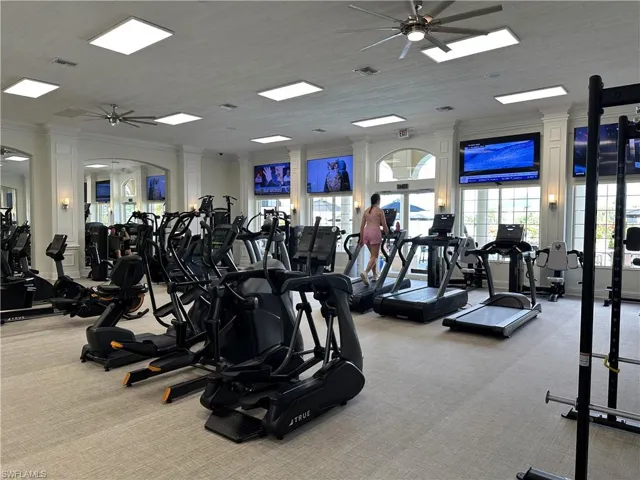 Gym featuring a ceiling fan and ornamental molding