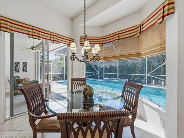 Dining space with a sunroom and a ceiling fan