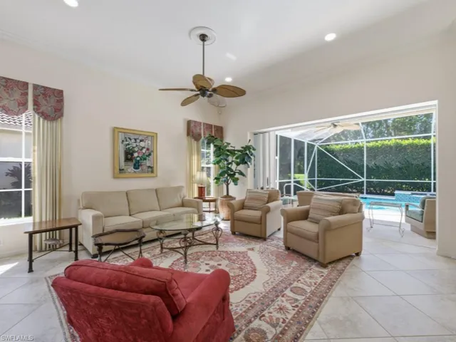 Living room featuring a sunroom, ceiling fan, light tile patterned floors, and recessed lighting