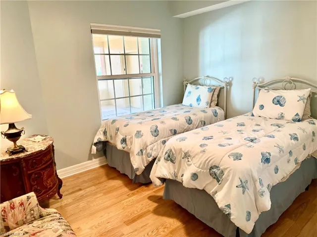 Bedroom with light wood-style floors and baseboards