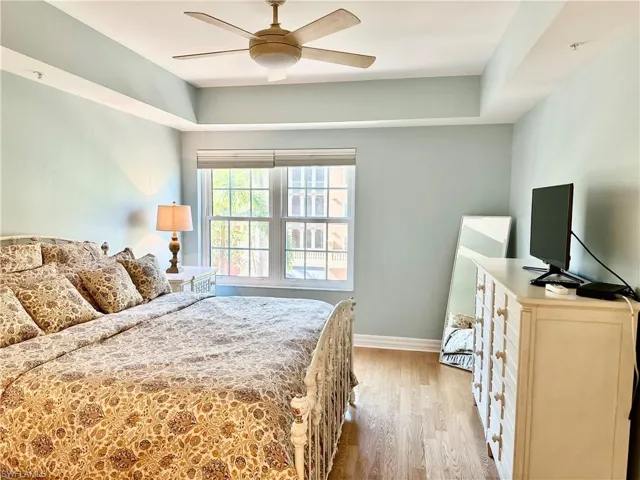Bedroom with light wood-style floors and a ceiling fan