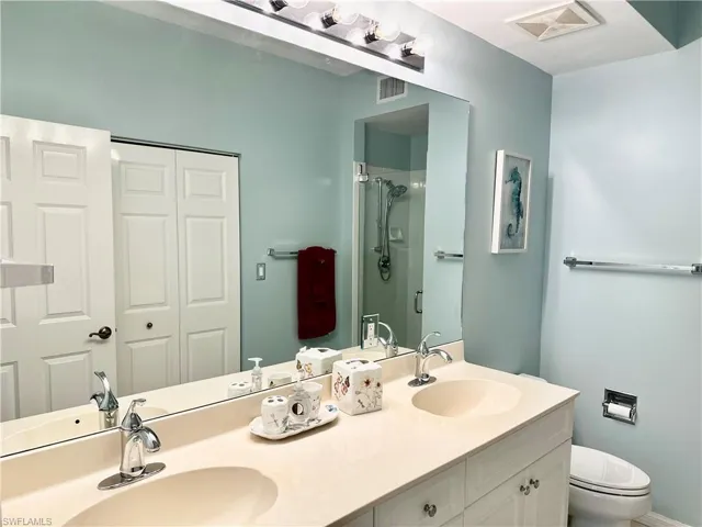 Bathroom with a stall shower and double vanity