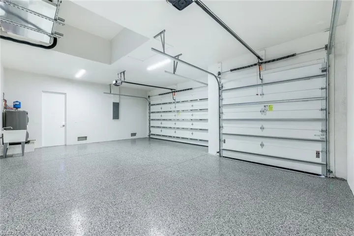 Garage with electric panel and a garage door opener