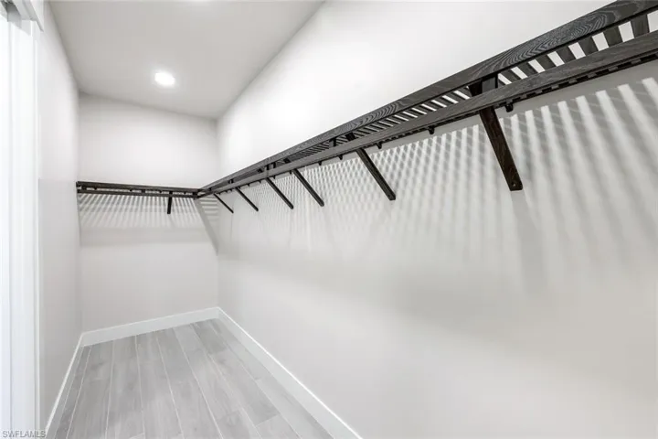 Walk in closet featuring hardwood / wood-style flooring