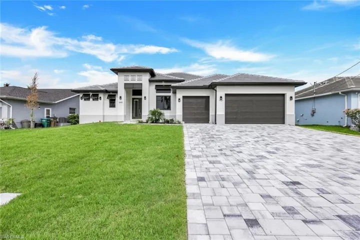Prairie-style home with a garage and a front lawn