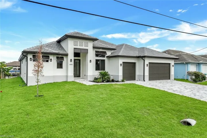 Prairie-style home with a front yard and a garage