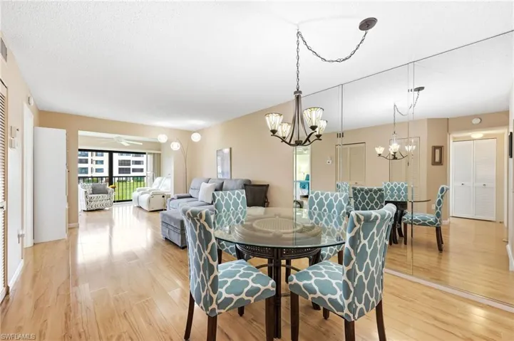 Open concept living and dining area featuring wood-finish flooring throughout
