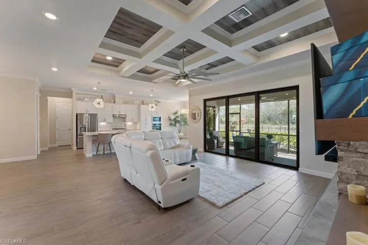 Living area featuring ornamental molding, wood finish floors, coffered ceiling, ceiling fan, and recessed lighting