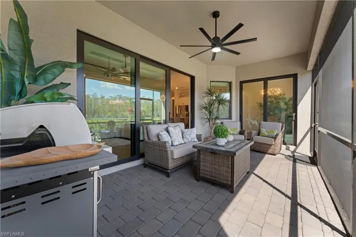 Sunroom featuring a ceiling fan, an outdoor lounge area, and a patio area