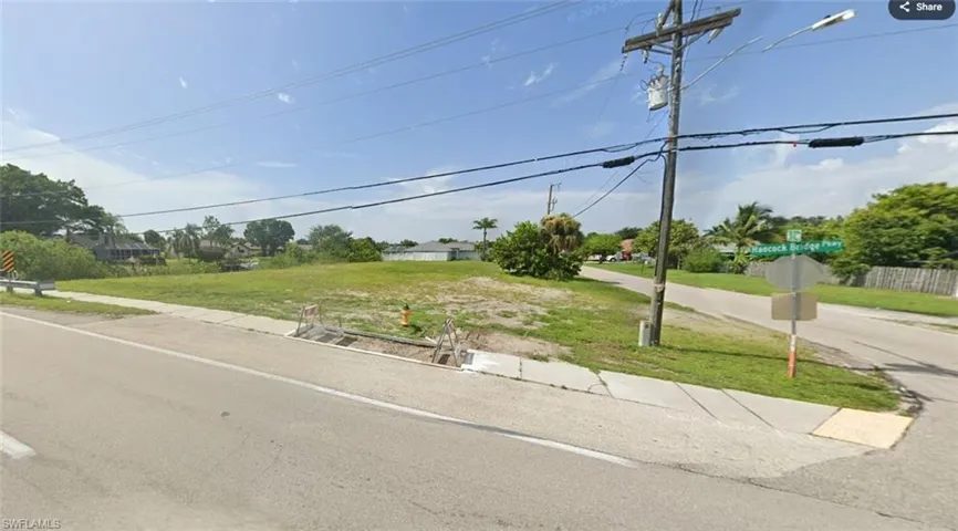 View of asphalt road featuring traffic signs and sidewalks