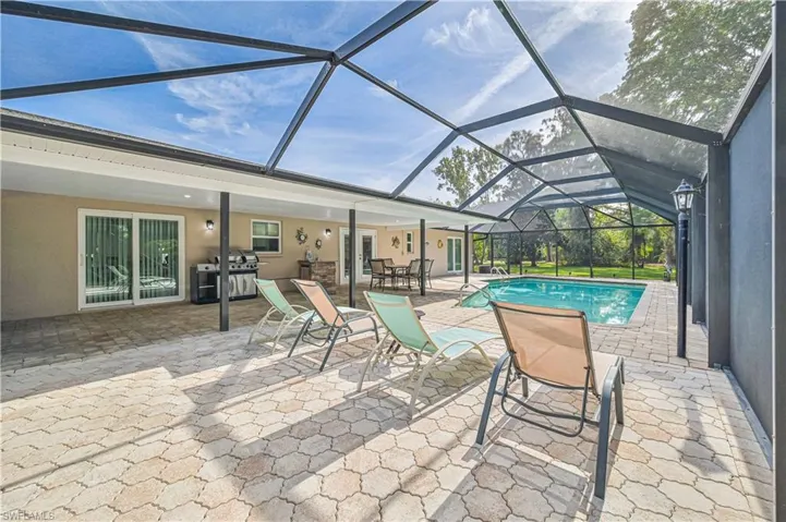 View of pool featuring a patio, grilling area, and a lanai