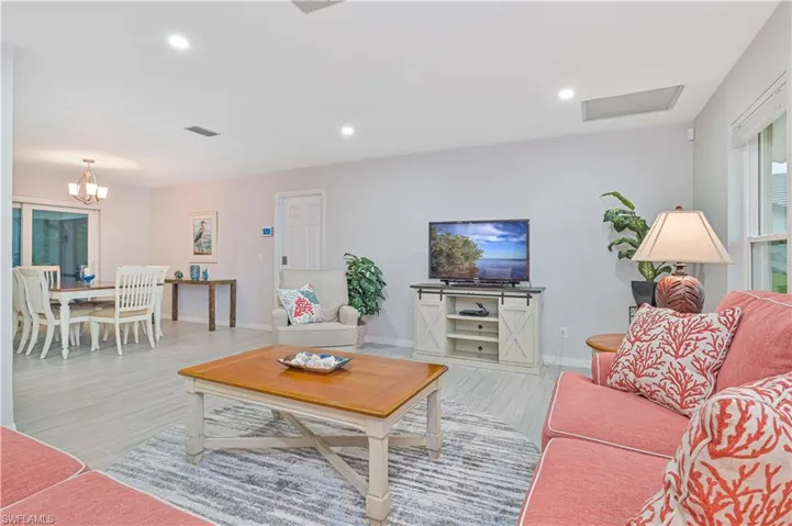 Living room with a chandelier and light wood-type flooring