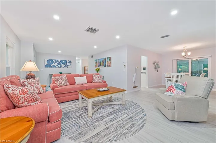 Living room with a chandelier and light wood-type flooring