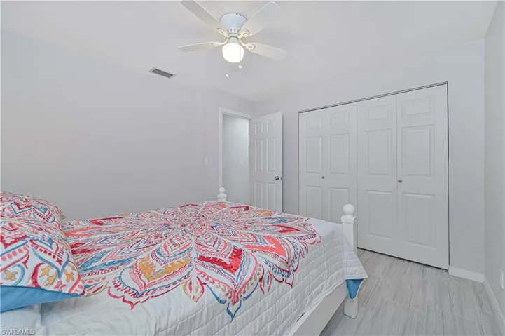 Bedroom with ceiling fan and a closet