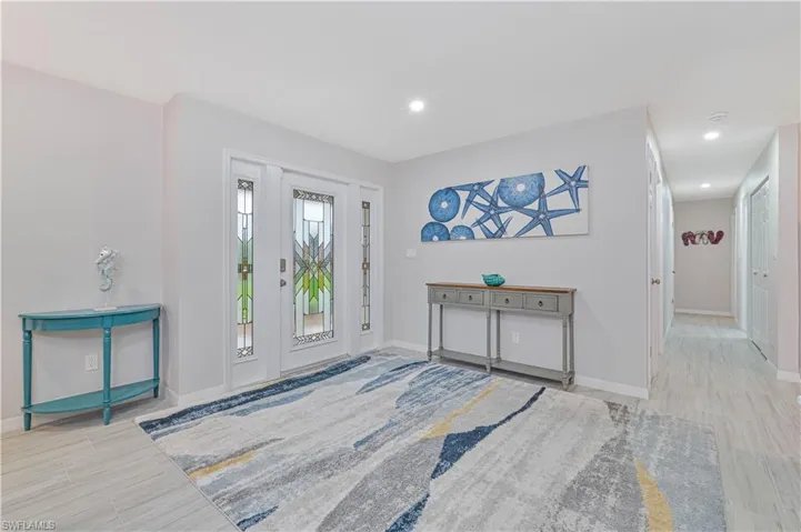 Entrance foyer with light hardwood / wood-style floors
