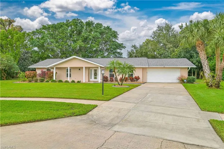 Single story home featuring a front lawn and a garage